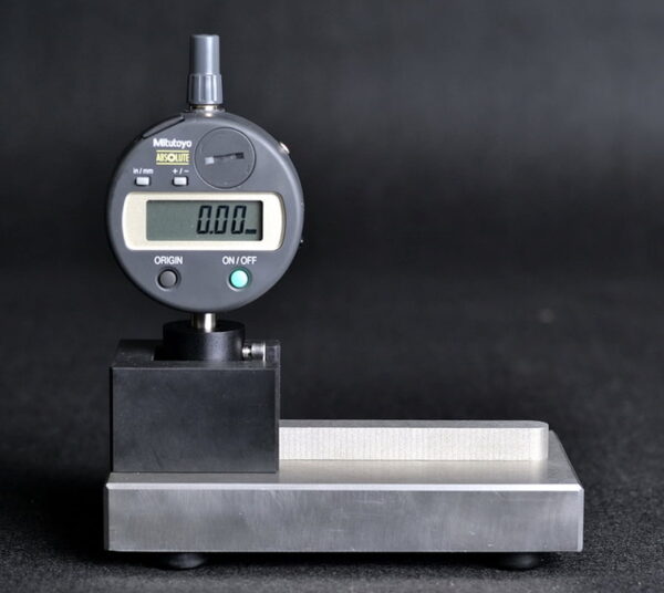 Digital Countersink Gauge measuring countersink depth in aluminum cans.