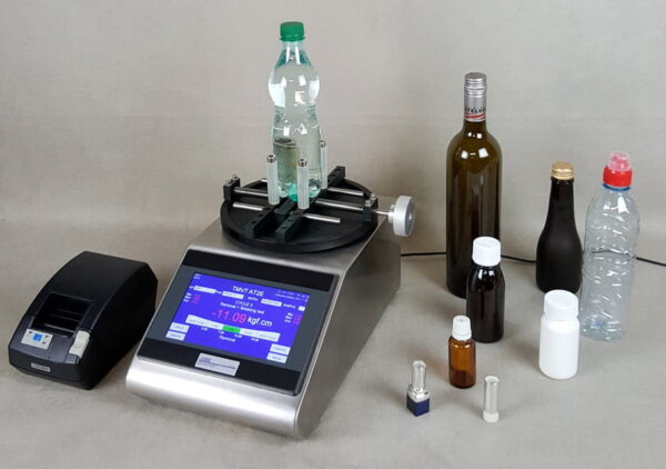 Torque tester with various bottles and a printer.