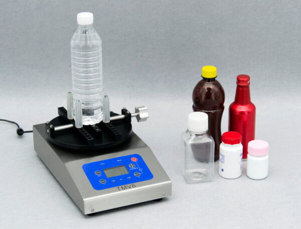 Laboratory equipment and chemical bottles on table.